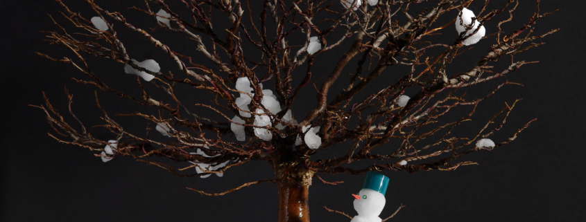 Bonsai with snow and snowman